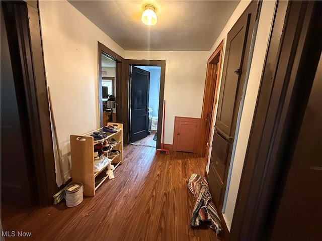 hallway with baseboards and wood finished floors
