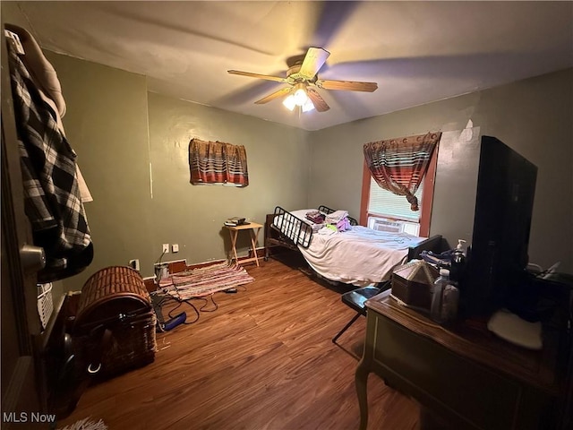 bedroom featuring a ceiling fan and wood finished floors