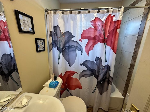bathroom featuring toilet and shower / bath combo