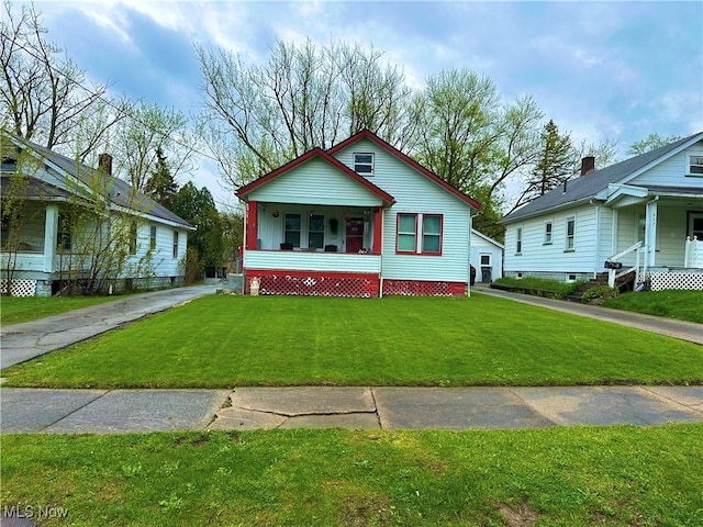 bungalow featuring a porch and a front lawn