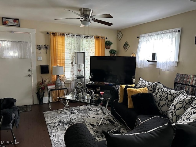 living area featuring a ceiling fan and wood finished floors