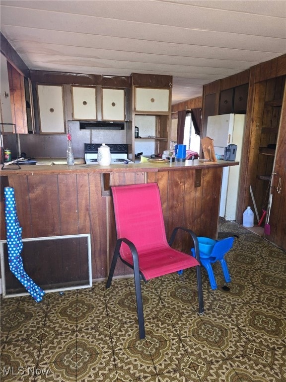 5961-5971 Streeter, Mantua, OH 44255 - kitchen with wooden walls, freestanding refrigerator, electric range, and extractor fan