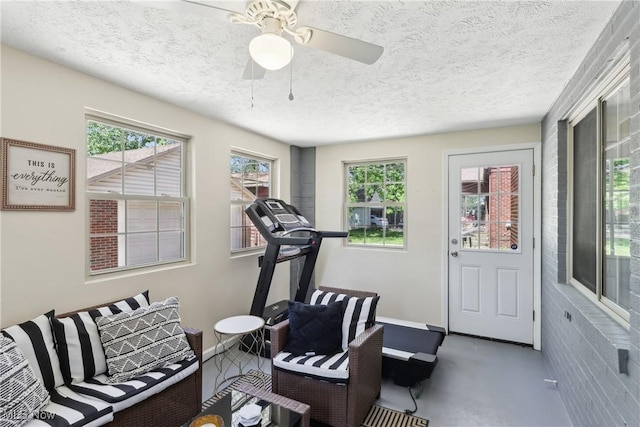 692 Roslyn Ave, Akron, OH 44320 - workout room with baseboards, a textured ceiling, and ceiling fan