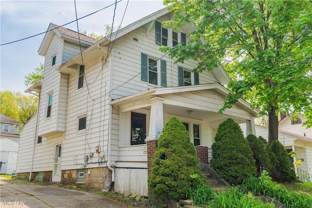view of side of property with a porch