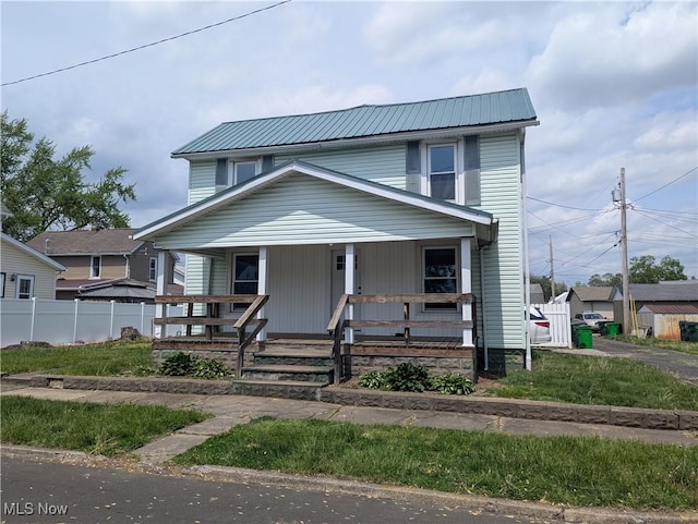 810 Pine St, Coshocton, OH 43812 - view of front facade featuring covered porch, fence, and metal roof