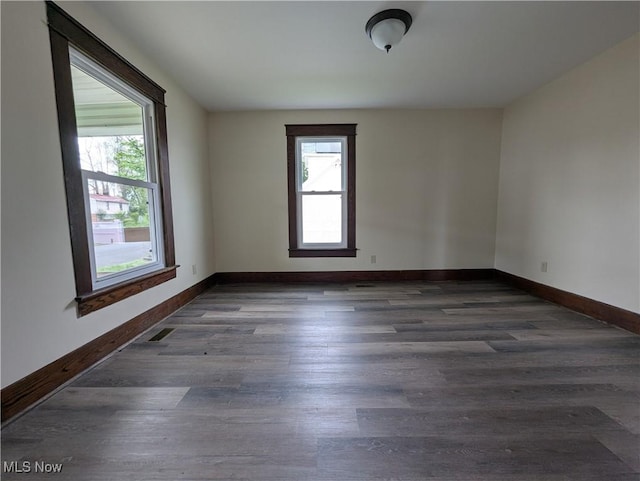 810 Pine St, Coshocton, OH 43812 - unfurnished room with baseboards, visible vents, wood finished floors, and a wealth of natural light
