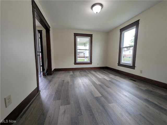 810 Pine St, Coshocton, OH 43812 - spare room featuring baseboards, wood finished floors, and a healthy amount of sunlight