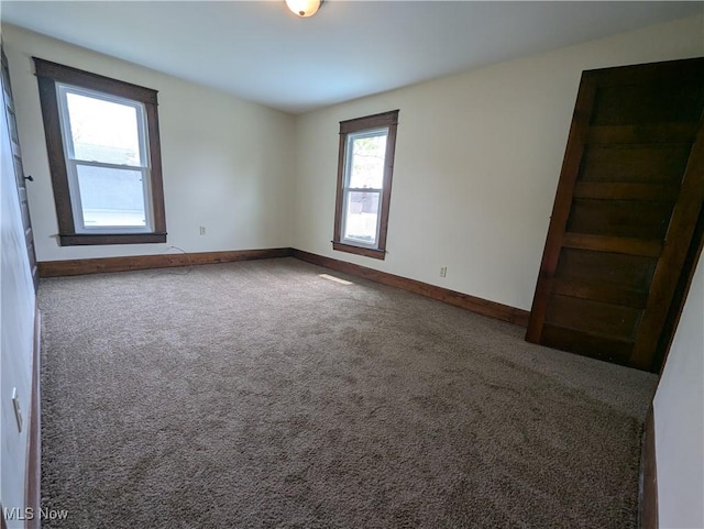 810 Pine St, Coshocton, OH 43812 - carpeted empty room with baseboards