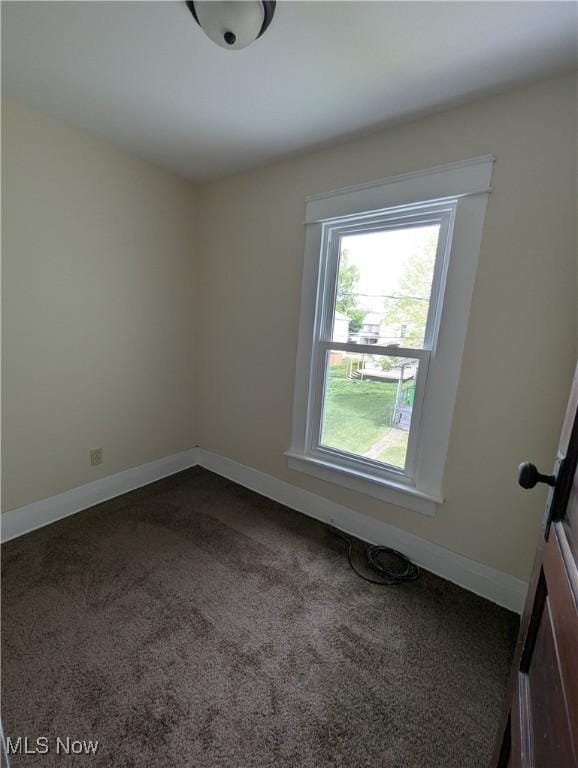 810 Pine St, Coshocton, OH 43812 - spare room with baseboards and dark carpet