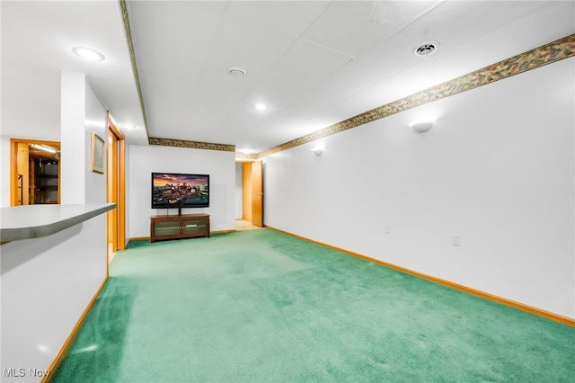 unfurnished living room featuring recessed lighting, baseboards, and light colored carpet