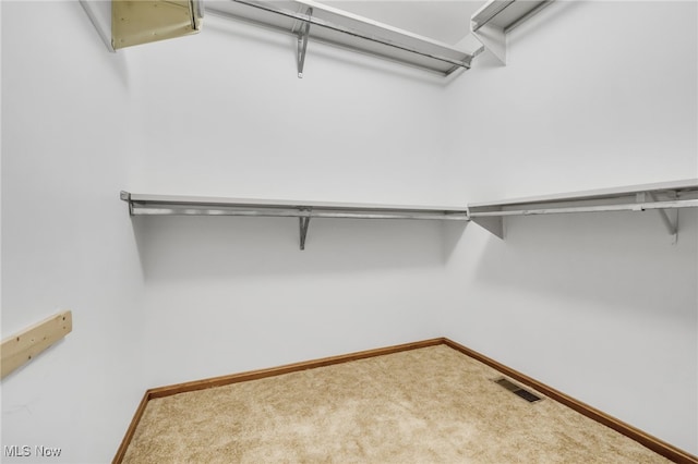 spacious closet with visible vents and carpet