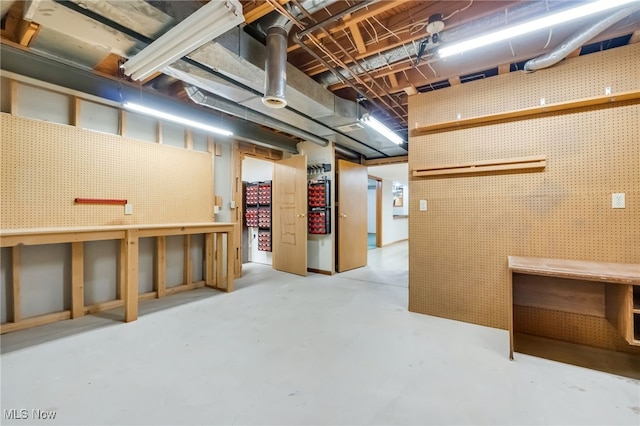 unfinished basement with a workshop area