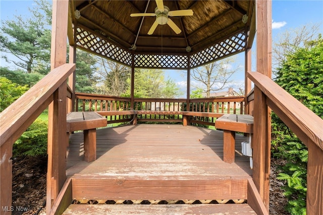 deck featuring ceiling fan and a gazebo
