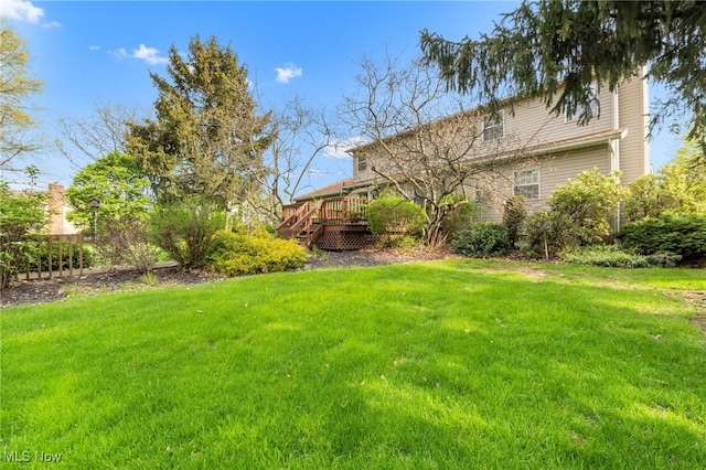 view of yard with a wooden deck and fence