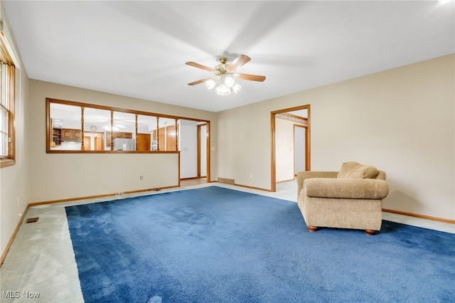 unfurnished room with carpet floors, a ceiling fan, baseboards, and visible vents