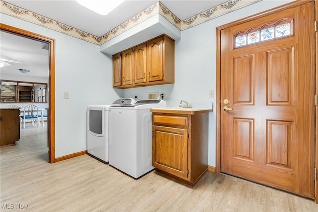 laundry room with washer and dryer, baseboards, ceiling fan, cabinet space, and light wood-style flooring