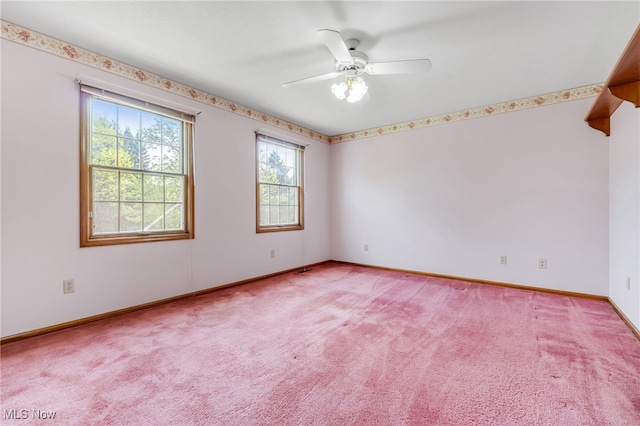 unfurnished room with light colored carpet, baseboards, and ceiling fan
