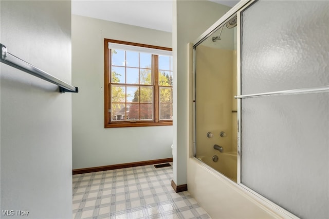 full bath with visible vents, tile patterned floors, baseboards, bath / shower combo with glass door, and toilet