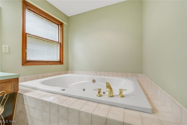 bathroom featuring a whirlpool tub and vanity