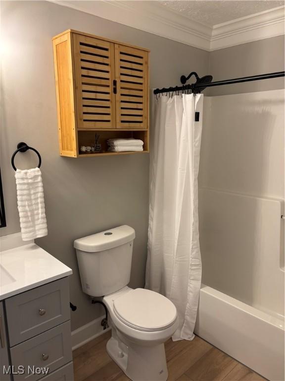full bath with crown molding, vanity, toilet, and wood finished floors