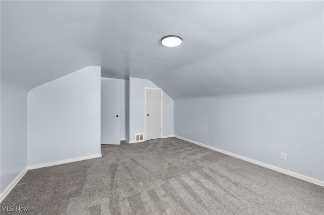 bonus room with visible vents, baseboards, carpet, and lofted ceiling