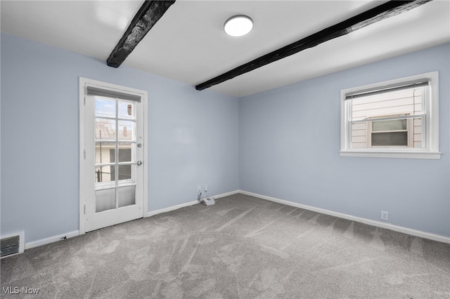 unfurnished room featuring carpet floors, baseboards, beam ceiling, and visible vents