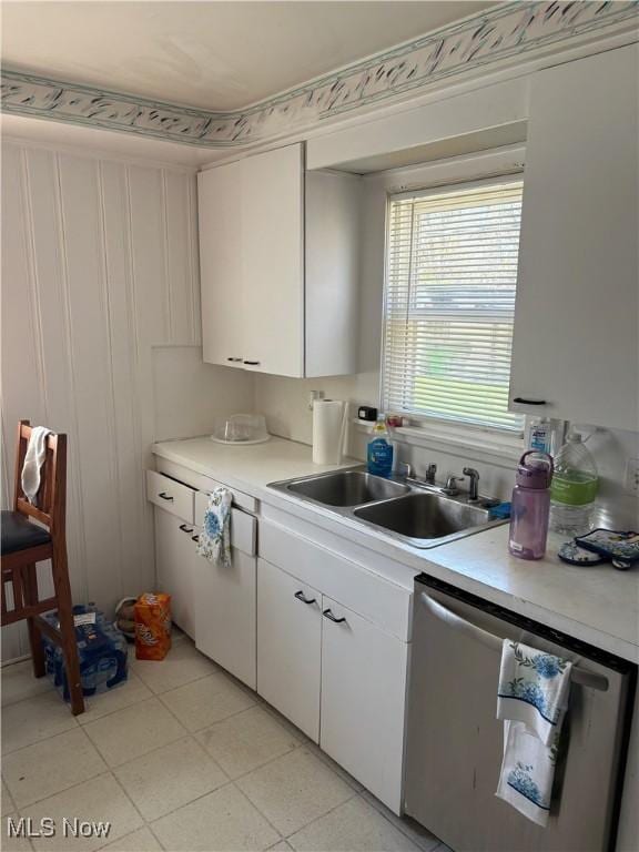 kitchen with light countertops, white cabinetry, a sink, and dishwasher