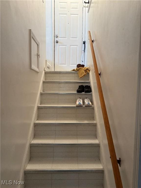stairway featuring tile patterned floors