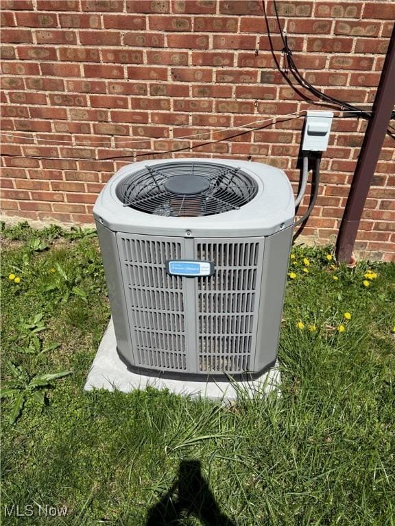 details with central air condition unit and brick siding