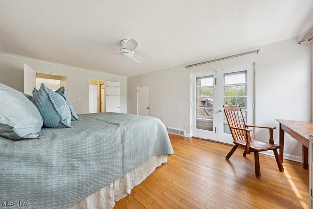bedroom with ceiling fan, french doors, light wood-style flooring, baseboards, and visible vents