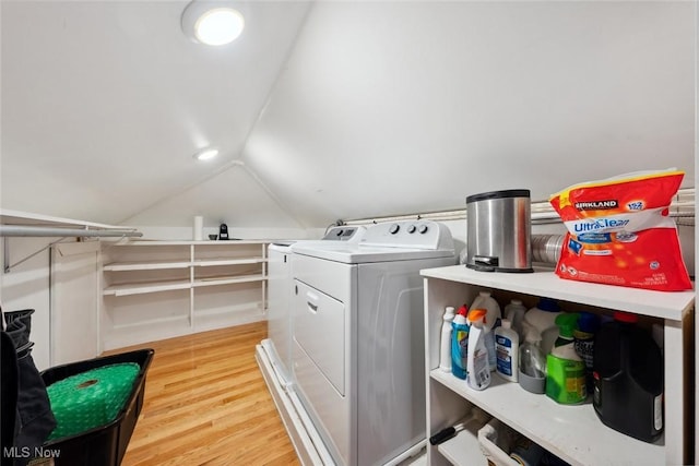 laundry area with laundry area, washer and clothes dryer, and light wood finished floors