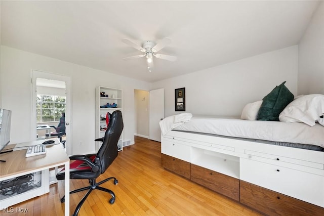 bedroom with a ceiling fan and light wood-type flooring