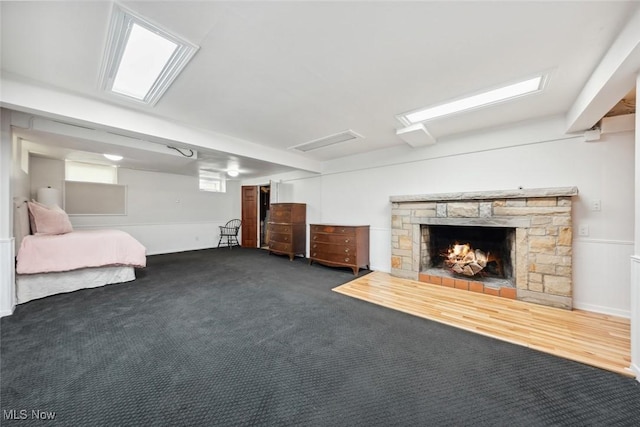 interior space featuring dark colored carpet and a fireplace