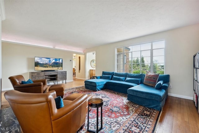 living room with baseboards and hardwood / wood-style floors