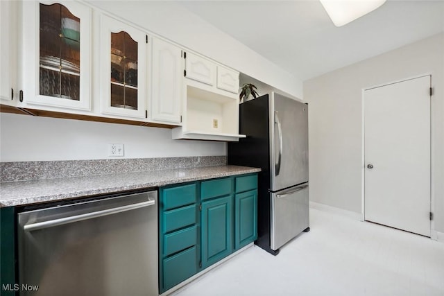 kitchen featuring glass insert cabinets, white cabinets, and stainless steel appliances
