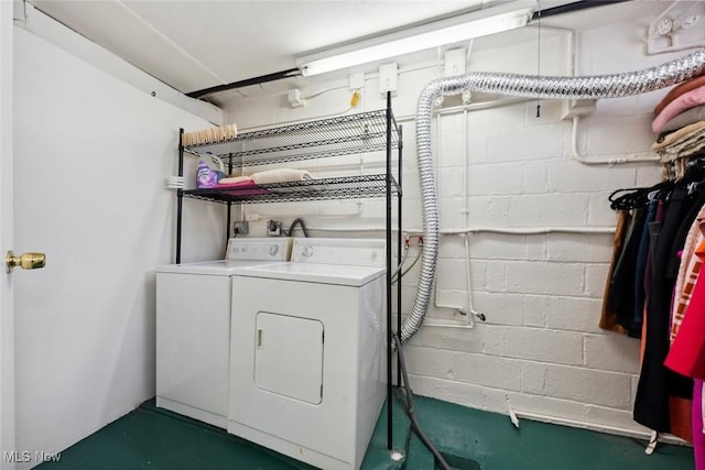 washroom with separate washer and dryer, laundry area, and concrete block wall