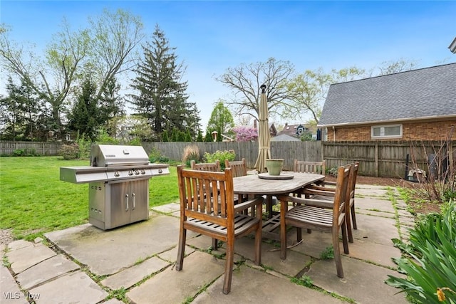 view of patio with a fenced backyard, outdoor dining space, and area for grilling