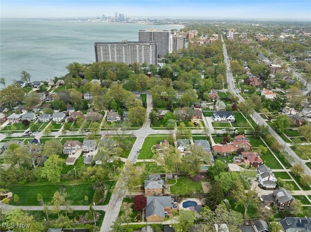 drone / aerial view featuring a water view, a residential view, and a view of city