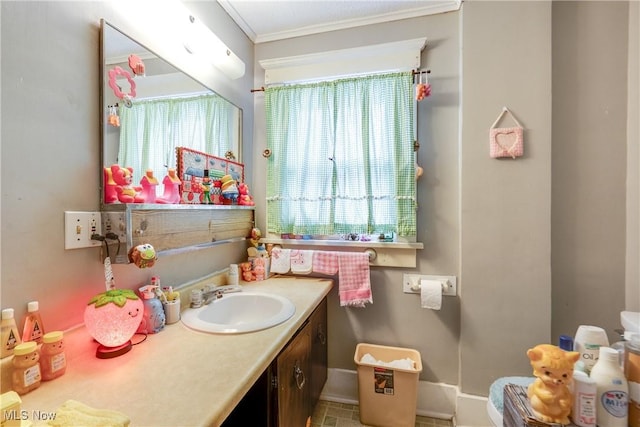 bathroom featuring vanity, ornamental molding, and baseboards
