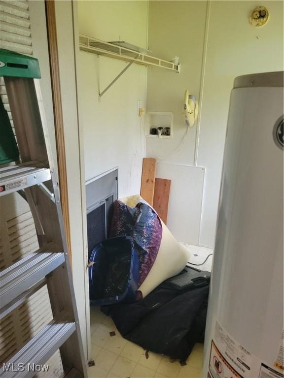 laundry room with laundry area, tile patterned floors, and gas water heater