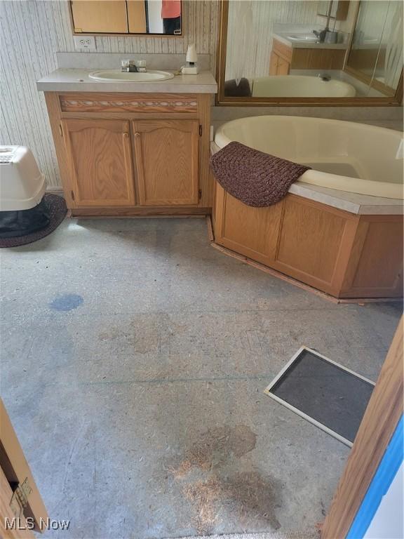 bathroom with vanity and a tub to relax in