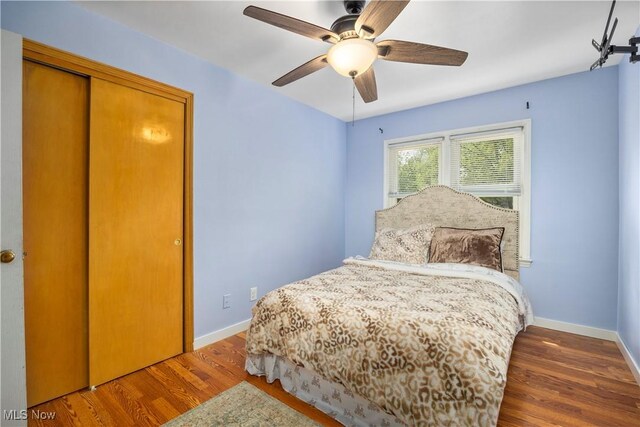 bedroom with baseboards, a ceiling fan, and wood finished floors