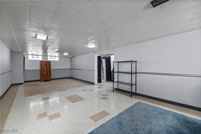 interior space featuring baseboards and speckled floor