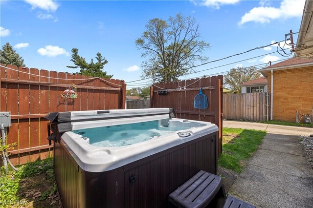 view of yard featuring a hot tub and fence