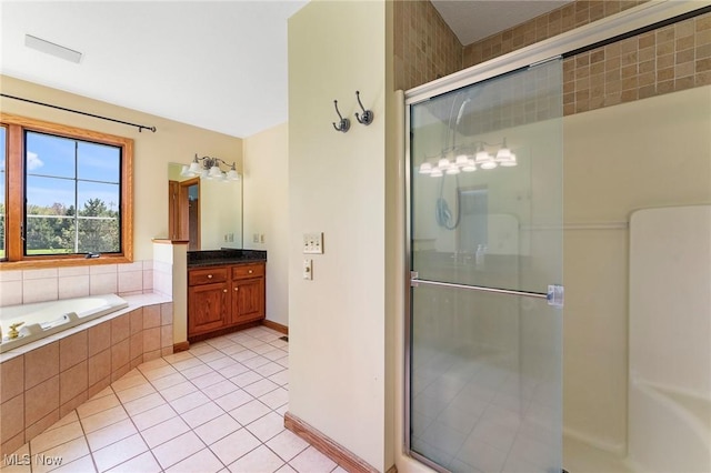 full bath with tile patterned flooring, vanity, a garden tub, visible vents, and a shower stall