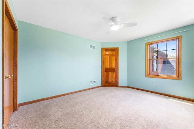 unfurnished bedroom with visible vents, carpet, ceiling fan, and baseboards