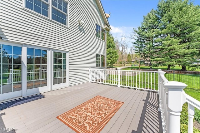 wooden deck featuring a lawn