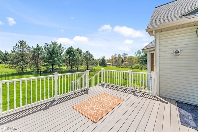 deck with a lawn and fence