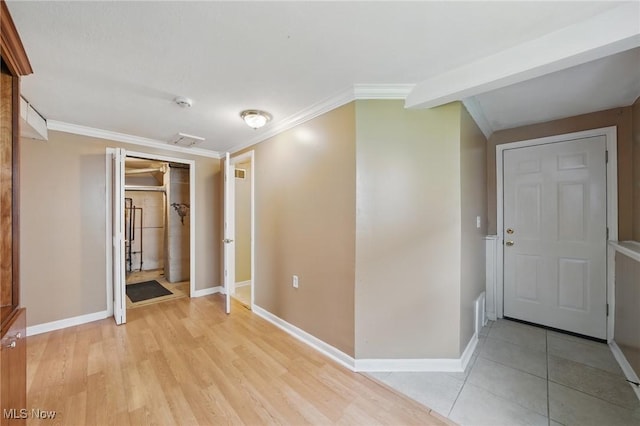 interior space featuring crown molding, baseboards, and a closet