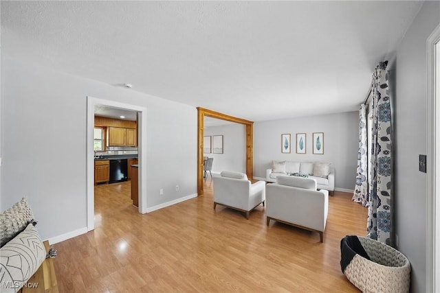 living area with light wood-style floors and baseboards